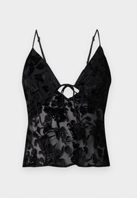 Melnā kamzola ar tievām siksnām, ar ziedu rakstu samta pārklājumā uz caurspīdīgas auduma; V-veida dekoltē un sasienamā detaļa priekšpusē.