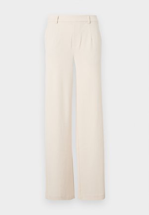 Helle beige weite Hosen mit vorderen Falten, einer glatten Textur und seitlichen Taschen. Hergestellt aus einem weichen Stoff mit einem maßgeschneiderten Design.