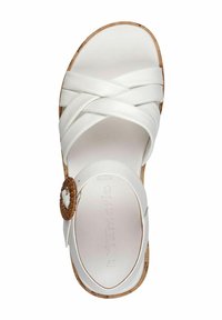 Bílé sandály s kříženými pásky, texturovanou stélkou a tkaným akcentem. Podešev připomínající korek s kulatým tvarem. Číslo modelu 37.