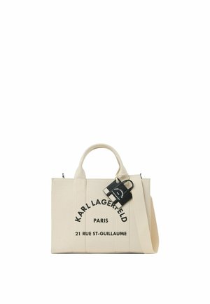 Sac cabas beige Karl Lagerfeld avec texte du logo noir et adresse, petite pochette noire attachée et bandoulière beige.