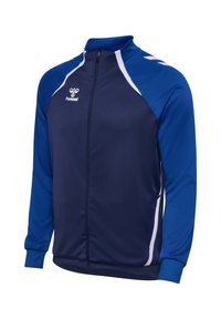 Námornícka modrá športová bunda so svetlomodrými ramennými akcentmi, bielymi pruhmi, vysokým golierom, plným zipsom a elastickými manžetami. Logo značky na hrudi.