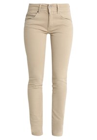 Béžové skinny džínsy s hladkým bavlněným zložením, které mají přední kapsy a zapínání na knoflík. Látka má mírnou pružnost pro pohodlí.