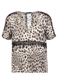 Blouse imprimée léopard en beige et noir. Manches courtes, décolleté en V, avec des détails en dentelle le long de la taille et de l'ouverture à l'arrière. Texture soyeuse.