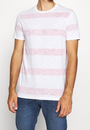 White short-sleeved t-shirt featuring horizontal light red stripes, constructed from a soft, textured fabric. Blue jeans are also visible.