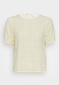 Blusa amarela com padrão xadrez, com mangas bufantes, apresentando um tecido texturizado e um fecho de laço nas costas. Corte regular e leve.