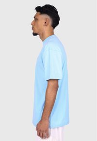 Light blue short-sleeved T-shirt in soft cotton, featuring a straight cut and crew neck, with no visible patterns or accents.