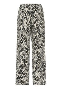 Pantalon coupe ample avec motif de coups de pinceau noirs irréguliers sur fond blanc, taille élastique, jambes droites.