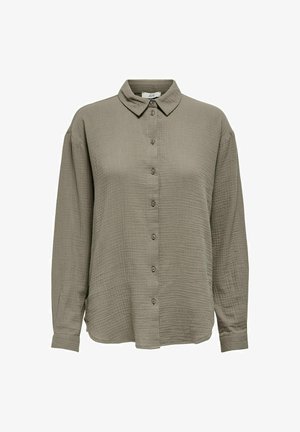 Alyvuogių žalios spalvos marškiniai su mygtukais iš lengvos, tekstūruotos medžiagos, su smailiu apykakle ir ilgomis rankovėmis, su mygtukais priekyje.