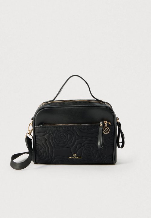 Schwarze Handtasche mit gestepptem Rosenmuster, goldfarbenen Beschlägen und zwei Reißverschlussfächern. Verfügt über einen oberen Griff und verstellbaren Riemen.