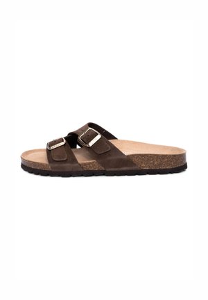 Brown suede sandal with two adjustable silver buckles, cork footbed, and black textured sole, shown in side profile on white background.