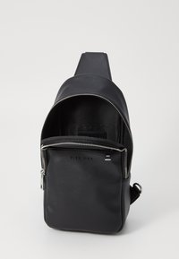 Black leather backpack with a zip closure, adjustable strap, and interior compartment. Features a smooth texture and minimal branding.