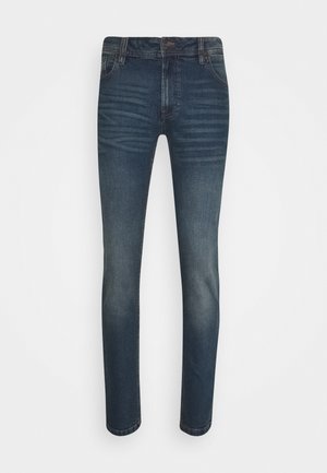 Tmavě modré džíny se slim fit, které mají klasický pětikapsový design, vybledlé oblasti a jemné texturované linie na přední straně.