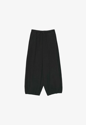 Rastezljive crne široke hlače s elastičnim pojasom i manšetama, s bočnim džepovima i opuštenim krojem.