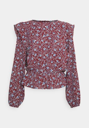 Long-sleeve maroon blouse with blue and white floral pattern, ruffled shoulders, and elastic cinched waist.