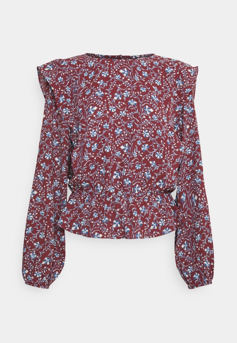 Blouse bordeaux à manches longues avec motif floral bleu et blanc, épaules volantées et taille élastiquée cintrée.