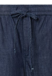 Dark blue denim pants with elastic waistband and tied fabric drawstring at the front center.