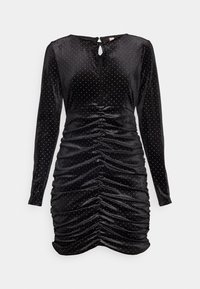 Robe noire à manches longues en tissu doux, avec des accents de points argentés, un dos à ouverture en trou de serrure et des détails froncés sur le côté pour un effet drapé.