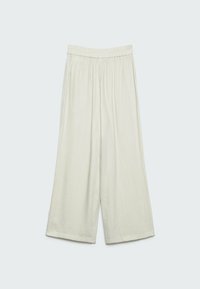 Pantalon beige clair à jambes larges avec taille élastique et tissu texturé, offrant une coupe décontractée et une longueur raccourcie.