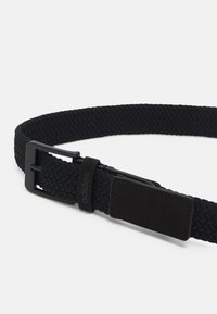 Black woven belt featuring a rectangular buckle, textured material, and a leather accent with brand logo. Adjustable for a secure fit.