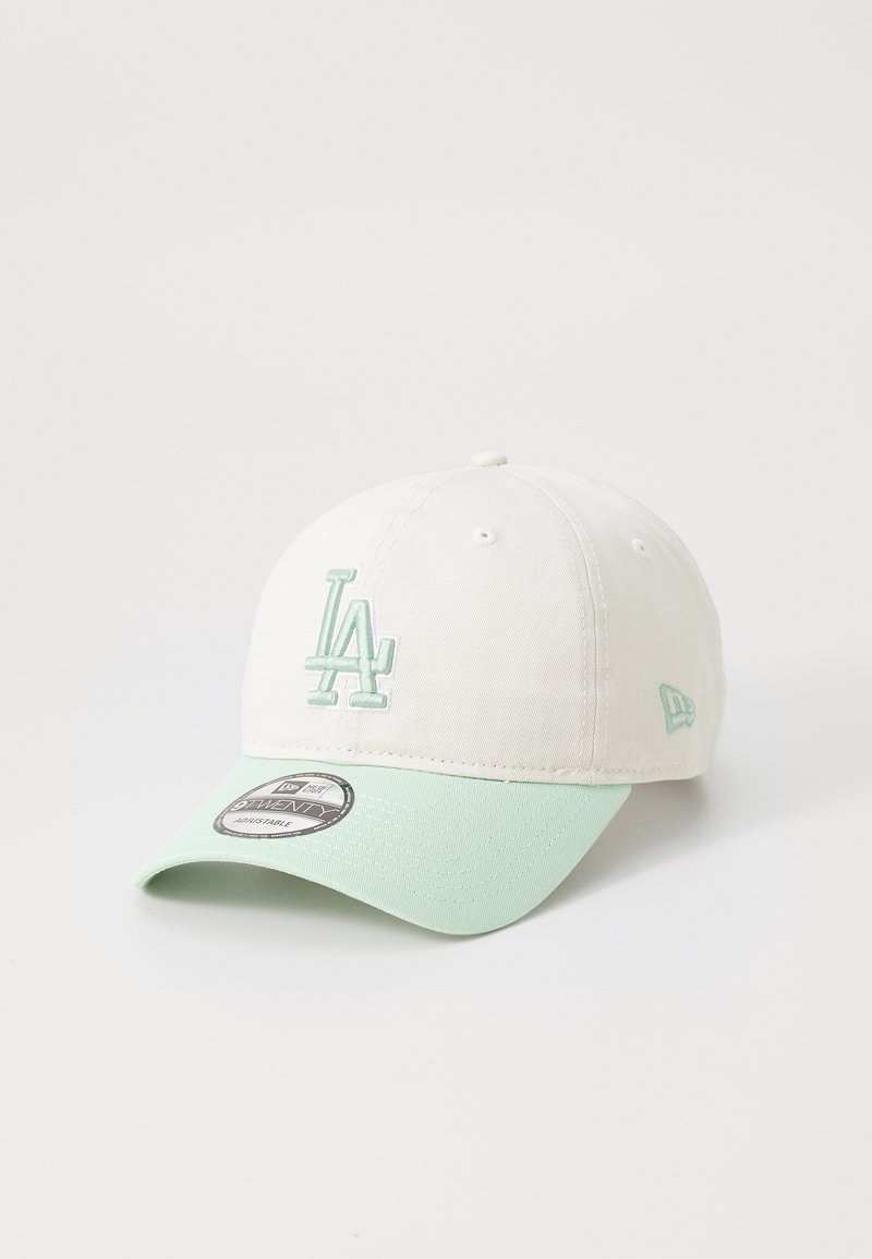 White cap with a mint green brim. Features a stitched "LA" logo in mint green on the front and a New Era tag on the brim.