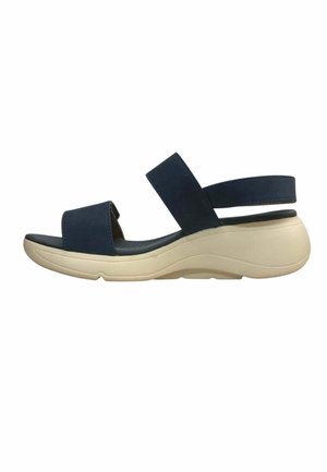 Navy blue sandal with two wide straps and beige cushioned sole designed for comfort and casual wear.
