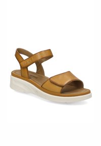 Brune lædersandal med åben tå-design, dobbelt justerbare stropper og en hvid polstret sål for komfort og støtte.