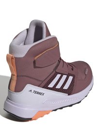 Purple hiking boot featuring a padded collar, white stripes, reinforced toe cap, and a textured synthetic upper with a rubber outsole.