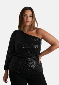 Top nero a spalla unica realizzato in materiale paillettato con una finitura testurizzata; vestibilità ampia e manica lunga da un lato, con un collo rilassato.