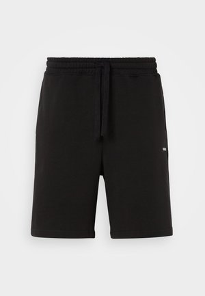 Pantaloni corti neri in cotone con vita elasticizzata e cordoncino. Presentano tasche laterali e un piccolo logo sulla parte anteriore. Texture liscia.
