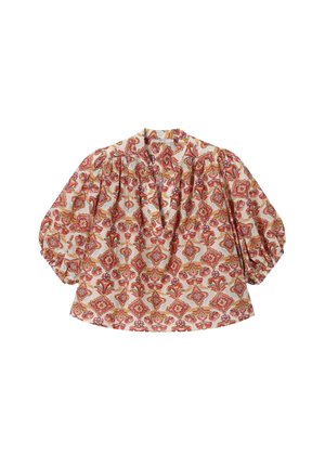 Blouse à manches bouffantes et col en V, avec un motif floral et géométrique orange, rose et jaune sur fond crème.