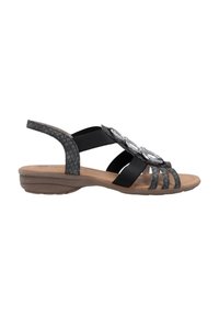 Schwarze Sandalen mit elastischen Bändern, die ein dekoratives metallisches Detail und eine gepolsterte beigefarbene Sohle aufweisen. Texturierter Hinterriemen für Unterstützung.