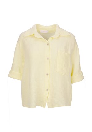 Kurzärmliges, knöpfbares Hemd aus weichem, gelbem, zerknittertem Stoff. Mit Kragen, Brusttasche und hochgerollten Ärmeln. Strukturierte Oberfläche.
