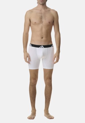 Weiße Boxer-Briefs mit einem schwarzen elastischen Bund, der ein Logo zeigt. Der Stoff wirkt glatt und dehnbar, mit einem taillierten Schnitt.