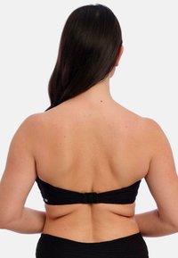 Černý bandeau bikini top z texturované tkaniny, s uzavíráním na sponu na zadní straně. Navržen bez ramínek pro minimální opálení.