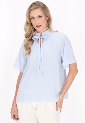 Light blue blouse with short sleeves, featuring a pleated collar and tie detail at the neckline. Soft fabric with a smooth texture.