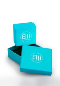 Coffrets cadeaux en carton turquoise avec une finition mate, arborant un logo circulaire blanc portant l'inscription "Elli par Julie & Grace." Une boîte est ouverte.