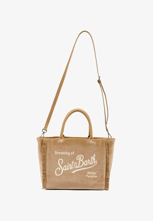 Beige canvas draagtas met franjes, dubbele handvaten en een afneembare schouderband. Voorzien van witte tekst: "Dromen van Saint Barth Winterparadijs."