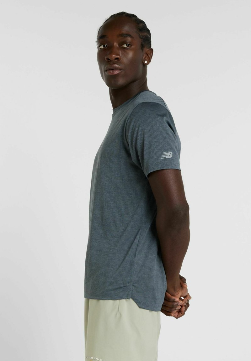 Gray, short-sleeve athletic t-shirt made of breathable material, featuring a subtle texture and a small logo on the left sleeve.