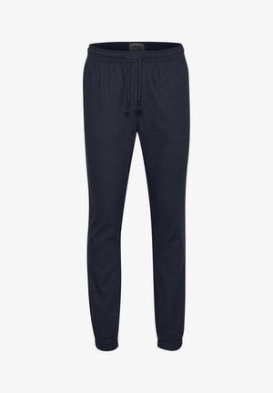 Navy blue jogger pants made of soft fabric with an elastic waistband, drawstring, and tapered cuffs for a relaxed fit.