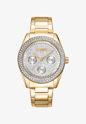 Orologio dorato con quadrante argento testurizzato scintillante, tre sottodial e una lunetta accentuata da cristalli. Bracciale a maglie metalliche. Marca: DKNY.