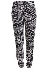 Black and white patterned pants featuring zigzag and geometric designs, elastic waistband, and a relaxed fit. Made from a lightweight fabric.