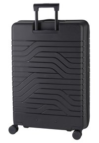 Valigia rigida nera con un motivo ondulato, manico estensibile e quattro ruote girevoli per una facile manovrabilità.