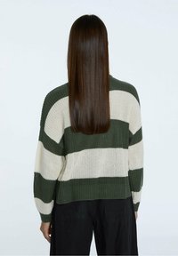 Green and cream striped knitted sweater with a relaxed fit, ribbed cuffs, and a cropped hem, showcasing a textured yarn pattern.