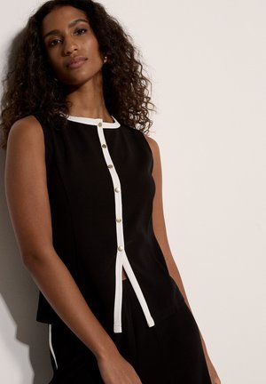 Top nero senza maniche con scollo rotondo, rifinito con bordino bianco a contrasto e bottoni dorati lungo la parte frontale. Texture liscia.