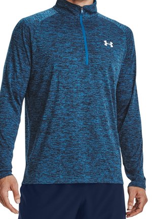 Pull-over de sport à manches longues pour homme bleu et noir moucheté avec une fermeture éclair quart de zip et logo blanc Under Armour sur le côté gauche de la poitrine.