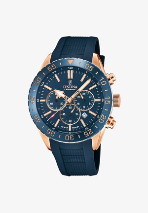 Reloj de cerámica azul marino con acentos en oro rosa, diales de cronógrafo, índices de horas elevados, correa de goma y cristal de zafiro. Resistente al agua hasta 10 bares.
