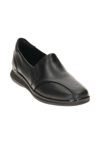 Zapatos de cuero negro tipo mocasín con punta redondeada, textura suave, detalles de costura mínimos y una suela negra resistente.