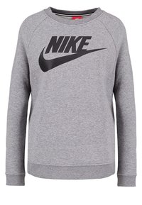 Šedá mikina s kulatým výstřihem a dlouhými rukávy. Na přední straně se nachází velké černé logo Nike. Vyrobena z texturované směsi bavlny.