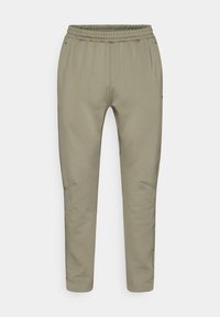 Φωτεινό ελιάς πράσινο παντελόνι jogger με κορδόνι στη μέση, στενόμακρα πόδια, πλαϊνές τσέπες με φερμουάρ και λείο, ελαστικό ύφασμα.