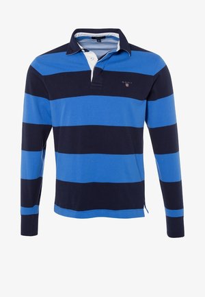 Maglia da rugby a manica lunga con ampie strisce orizzontali blu navy e blu brillante, patta con bottoni bianca e piccolo logo sul petto.